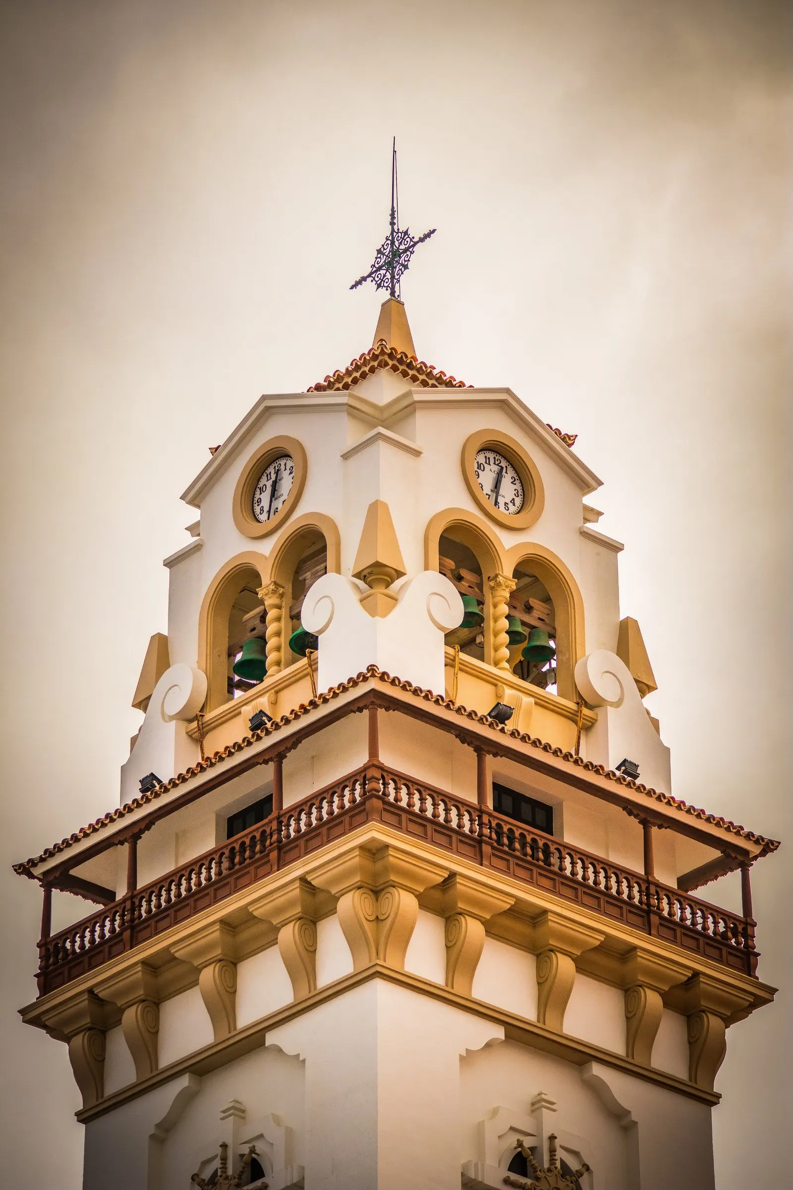 Bell tower of a church on Tenerife, shot from below against a warm sky